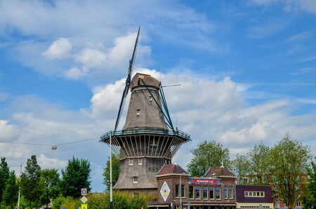 Amsterdam, Holland, August 2019.The De Gooyer Mill is located on the edge of the historic center:it is used as a brewery.Perfectly intact it is a dip in the past in the city.Blue sky with white cloudsのeditorial素材