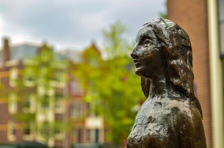 Amsterdam, Holland, August 2019. The statue of Anne Frank is a destination for many tourists: many pose for a souvenir photo with her. Here close-up image on the face of the statue.のeditorial素材