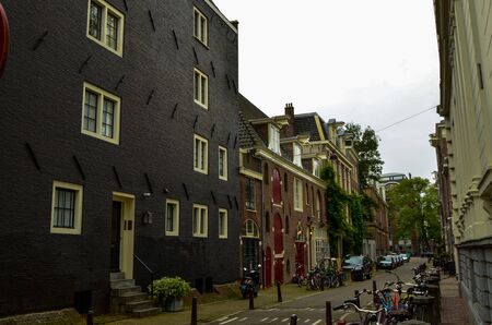 Amsterdam, Holland, August 2019. The typical and charming houses: they are a symbol of the city represented on a postcard. With brightly colored brick facades and distinctive roofs.のeditorial素材