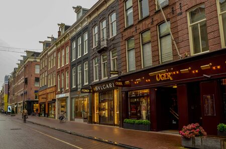 Amsterdam, Holland, August 2019. A rainy day in the shopping street: here are the shops with the most famous luxury fashion brands.のeditorial素材