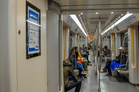 Amsterdam, Holland, August 2019. Interior view of the metro carriage: travelers are seated waiting for their stop.のeditorial素材