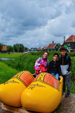 Zaanse Schans, Holland, August 2019. Northeast Amsterdam is a small community located on the Zaan River. At the shop of typical wooden clogs you can take a souvenir photo with two huge yellow clogs.のeditorial素材