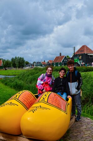 Zaanse Schans, Holland, August 2019. Northeast Amsterdam is a small community located on the Zaan River. At the shop of typical wooden clogs you can take a souvenir photo with two huge yellow clogs.のeditorial素材