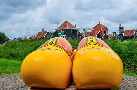 Zaanse Schans, Holland, August 2019. Northeast Amsterdam is a small community located on the Zaan River. At the shop of typical wooden clogs you can take a souvenir photo with two huge yellow clogs.のeditorial素材
