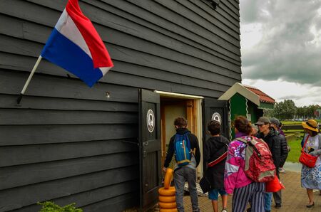 Zaanse Schans,Holland, August 2019.Northeast Amsterdam is a small community located on the Zaan River. The entrance of the shop of typical Dutch cheeses. Some forms of yellow cheese are on the ground.のeditorial素材