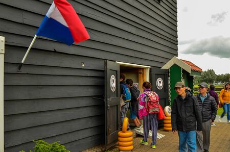 Zaanse Schans,Holland, August 2019.Northeast Amsterdam is a small community located on the Zaan River. The entrance of the shop of typical Dutch cheeses. Some forms of yellow cheese are on the ground.のeditorial素材