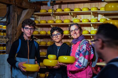 Zaanse Schans, Holland, August 2019. Northeast Amsterdam is a small community located on the Zaan River. In the shop of typical Dutch cheeses you can take a souvenir photo.のeditorial素材