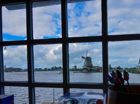 Zaanse Schans, Holland, August 2019. Northeast of Amsterdam on the Zaan River. A particular point of view from the inside of a mill: from the window you can see the typical landscape with the mills.のeditorial素材