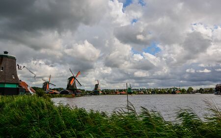 Zaanse Schans, Holland, August 2019. Northeast Amsterdam is located on the Zaan River. View of the mills on the river bankCloudy day. The first on the left is under maintenance: it is headless.のeditorial素材