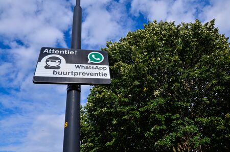 Edam, Netherlands, August 2019. A sign indicating a neighborhood watch is active in the area, using Whatsapp for communication (Dutch: buurtpreventie).のeditorial素材