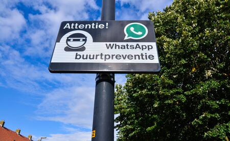 Edam, Netherlands, August 2019. A sign indicating a neighborhood watch is active in the area, using Whatsapp for communication (Dutch: buurtpreventie).のeditorial素材