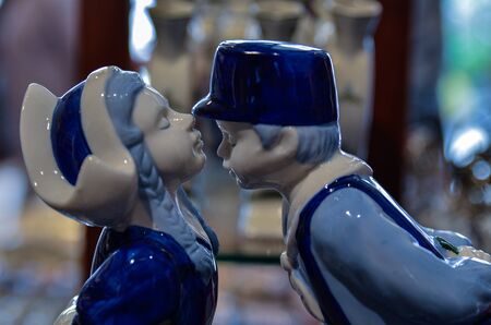 Delft, the netherlands, august 2019. The couple kissing at a shop of the famous white and blue ceramics: a very appreciated and famous souvenir.のeditorial素材