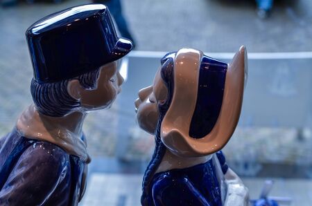 Delft, the netherlands, august 2019. The couple kissing at a shop of the famous white and blue ceramics: a very appreciated and famous souvenir.のeditorial素材