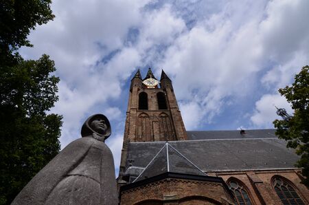 Delft, Holland, August 2019. The bell tower of the old church, the Oude Kerk, stands out imposingly over the cityのeditorial素材