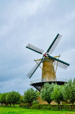 Goes, the netherlands, august 2019. In the countryside of the zealand region, a perfectly preserved and functioning windmill. Typical postcard landscape of the Dutch countryside.のeditorial素材