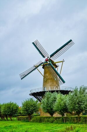 Goes, the netherlands, august 2019. In the countryside of the zealand region, a perfectly preserved and functioning windmill. Typical postcard landscape of the Dutch countryside.のeditorial素材