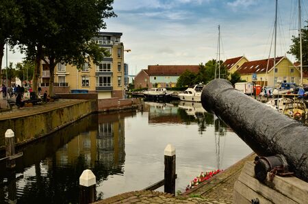 Goes, the Netherlands, August 2019. The port in the historic center, an ancient cannon remained to guard the entrance. His mouth points threateningly towards the incoming boats.のeditorial素材