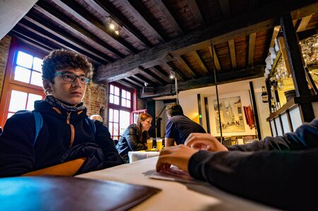 Bruges, flanders, Belgium. August 2019. Interior of the historic de garre brewery. The wooden beams, the furniture, the brick walls announce a jump into the past.のeditorial素材
