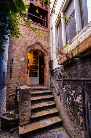 Bruges, flanders, Belgium. August 2019. The entrance to the historic de garre brewery. Six steps lead to the threshold: the red brick wall and the appearance herald a jump into the past.のeditorial素材