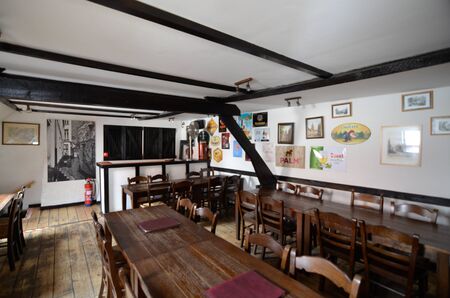 Bruges, flanders, Belgium. August 2019. Interior of the historic de garre brewery. The wooden beams, the furniture, the brick walls announce a jump into the past.のeditorial素材
