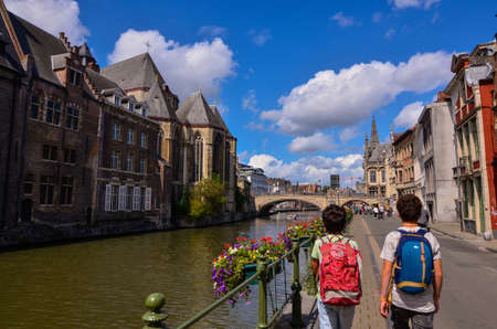 Ghent, Belgium, August 2019. Approaching the historic center, the canal bank with brightly colored planters brings the eye to the St. Michael's bridge. On the left the homonymous churchのeditorial素材