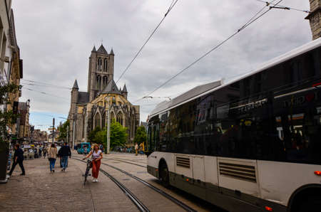 Ghent, Belgium, August 2019. View of the back of the St. Nicholas church. Blue sky with white clouds. People on the street.のeditorial素材
