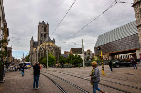 Ghent, Belgium, August 2019. View of the back of the St. Nicholas church. Blue sky with white...
