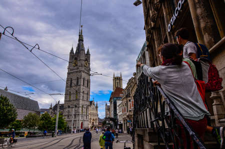 Ghent, Belgium, August 2019. The bell tower called Beffroi behind the church of St. Nicholas. A...