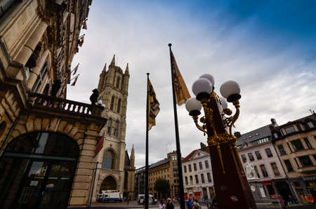 Ghent, Belgium, August 2019. View of the Saint Bavo Cathedral. Game of perspectives with a luxurious lamppost.のeditorial素材