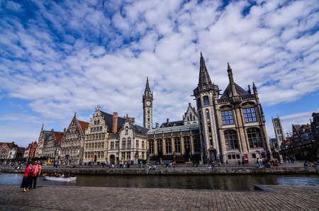 Ghent, Belgium, August 2019. Breathtaking cityscape: from the St. Michael bridge along the Graslei canal. One of the most beautiful postcards in the city. On the left a couple stopped to admire.のeditorial素材