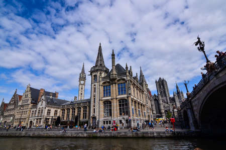 Ghent, Belgium, August 2019. Breathtaking cityscape: from the St. Michael's bridge to the street along the Graslei canal. One of the most beautiful postcards in the city. People stop to watch.のeditorial素材