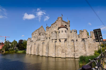 Ghent, Belgium, August 2019. The Gravensteen is the castle of the counts of Flanders. View from the side of the moat: the imposing medieval structure. Sunny day.のeditorial素材