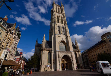 Ghent, Belgium, August 2019. View of the Saint Bavo Cathedral. People on the street, beautiful sunny day with blue sky and white clouds.のeditorial素材
