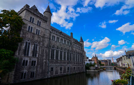 Ghent, Belgium, August 2019.Geraard de Duivelstraat Castle. The main facade overlooks the canal: it is an example of the medieval buildings of the city. Blue sky with white clouds.のeditorial素材