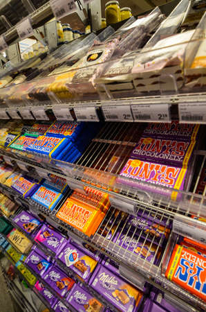 Ghent, Belgium, August 2019. Whole exhibitors dedicated to the Belgian specialty: chocolate at a supermarket. The packaging impresses with bright colors.のeditorial素材