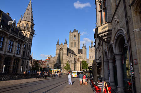 Ghent, Belgium, August 2019. In the historic center, one of the most beautiful views of the city: the bridge of St Michael.  in the direction of the church of San Nicola. People stop to enjoy the view.のeditorial素材