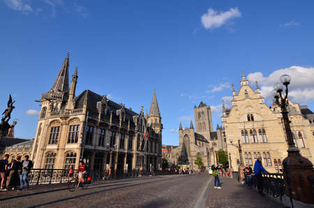 Ghent, Belgium, August 2019. In the historic center, one of the most beautiful views of the city: the bridge of St Michael.  in the direction of the church of San Nicola. People stop to enjoy the view.のeditorial素材