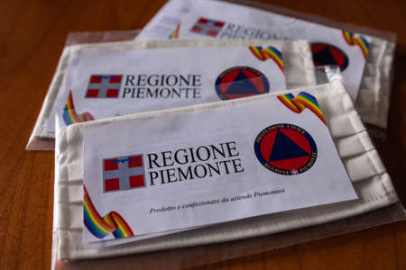 Turin, Piedmont, Italy. May 2020. Coronavirus. The region in collaboration with the civil protection, has delivered washable and reusable masks. Note the two logosのeditorial素材