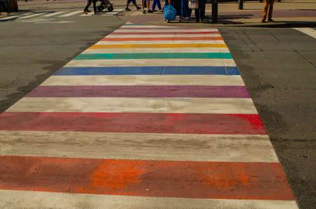 Antwerp, Flanders, Belgium. August 2019. Characteristic rainbow pedestrian crossings: with their bright colors they stand out immediately. Pedestrians are preparing to cross.のeditorial素材