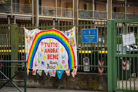 Turin,Piedmont,Italy. May 2020. Coronavirus pandemic. At the entrance of the school a sheet with the rainbow design has been hung and the message Everything will be fine" in Italian "AndrÃ  tutto bene"のeditorial素材