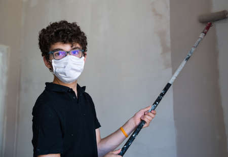 the Caucasian boy has a mask to protect himself from the virus.の写真素材