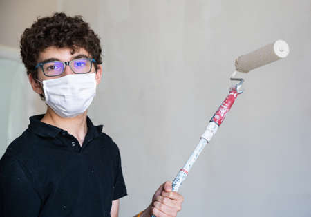 the Caucasian boy has a mask to protect himself from the virus.の写真素材