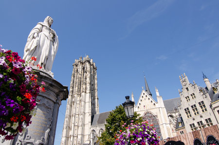 August 2019. Beautiful view of the cathedral in the background. In the foreground on the left, the statue of Margaretha van Oostenrijk decorated with brightly colored flower boxes.のeditorial素材