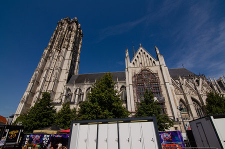 Belgium, August 2019. The imposing cathedral features a 97-meter bell tower in Gothic style. Beautiful summer day with blue sky.のeditorial素材