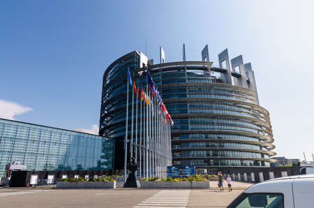 Strasbourg, France. August 2019.The entrance to the modern seat of the European parliament. A row of flagpoles with the flags of the member states of the European Union welcomes those who enter.のeditorial素材