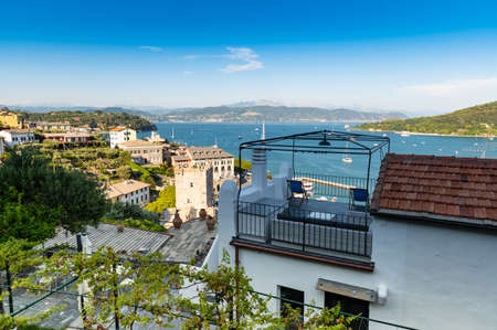 Porto Venere, Liguria, Italy. June 2020. Seascape from the hill of the village: behind the terraces of the houses a magnificent view of the bay crossed by numerous boats of various sizes.のeditorial素材