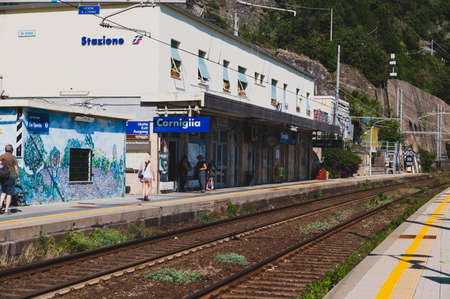 Corniglia, Liguria, Italy. June 2020. The train station on a sunny summer day. Some travelers are waiting for the train on the platform.のeditorial素材