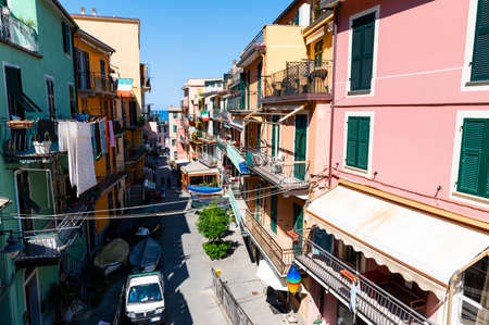 Manarola, Liguria, Italy. June 2020. The charm of the alleys of the seaside village, the houses with colored facades overlook the street. Beautiful summer day.のeditorial素材