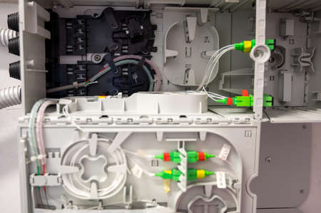 Close up shot of cabling of the optical fibers inside the distribution box.