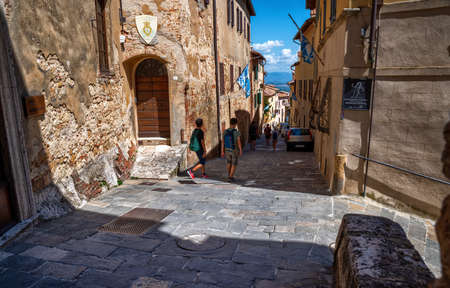 Montepulciano, Tuscany, Italy. August 2020. Stunning urban landscape with the main street rising to the top of the hill of the historic village. People on the street, beautiful summer day.のeditorial素材
